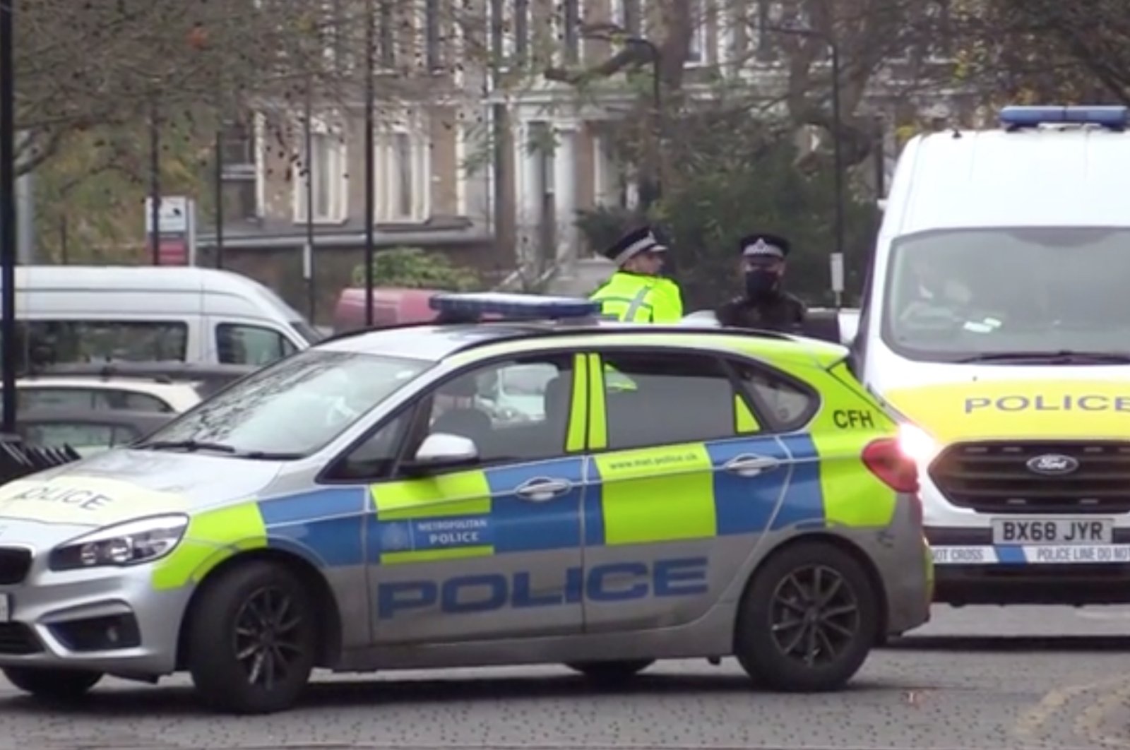 This screengrab from Anadolu Agency footage shows police forces near the school in London's Hackney, Dec. 10, 2020. (AA Photo)