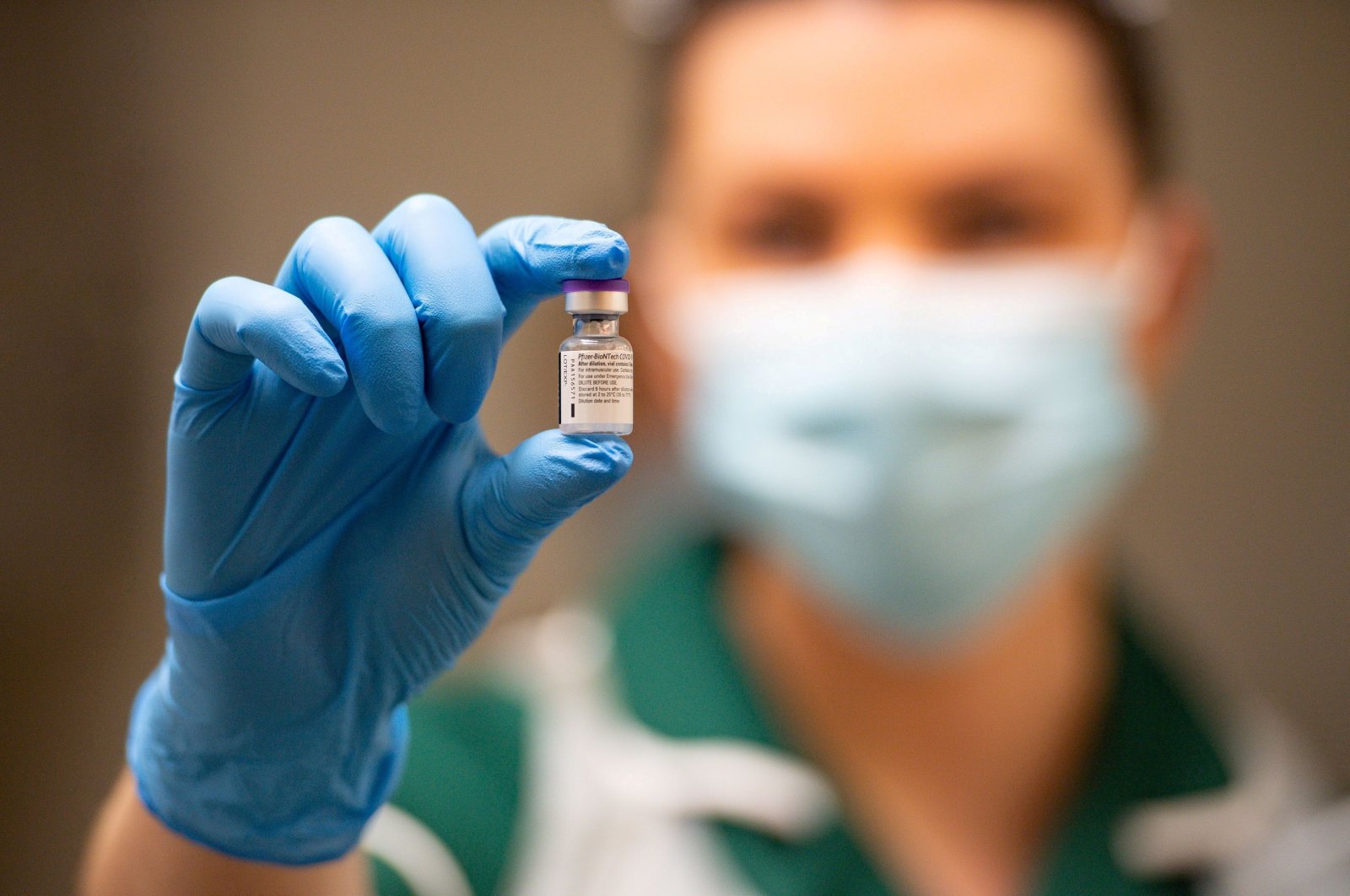 A nurse holds a vial of the Pfizer/BioNTech COVID-19 vaccine at University Hospital, on the first day of the largest immunization program in the British history, in Coventry, Britain December 8, 2020. (Reuters File Photo)