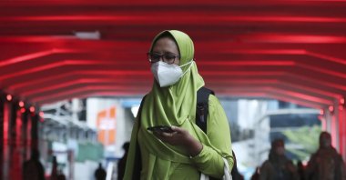 A woman wears a face mask to help curb the spread of the coronavirus in Jakarta, Indonesia. Monday, Dec. 7, 2020. (AP Photo)