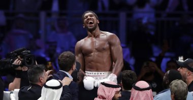 Anthony Joshua celebrates after beating Andy Ruiz Jr. to win their World Heavyweight Championship contest at the Diriyah Arena, Riyadh, Saudi Arabia, Dec. 8, 2020. (AP Photo)