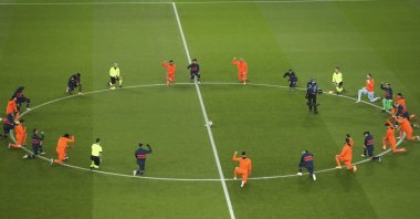Başaksehir and Paris Saint-Germain players take a knee before the start of the Champions League match at the Parc des Princes stadium in Paris, France, Dec. 9, 2020. (AP Photo)