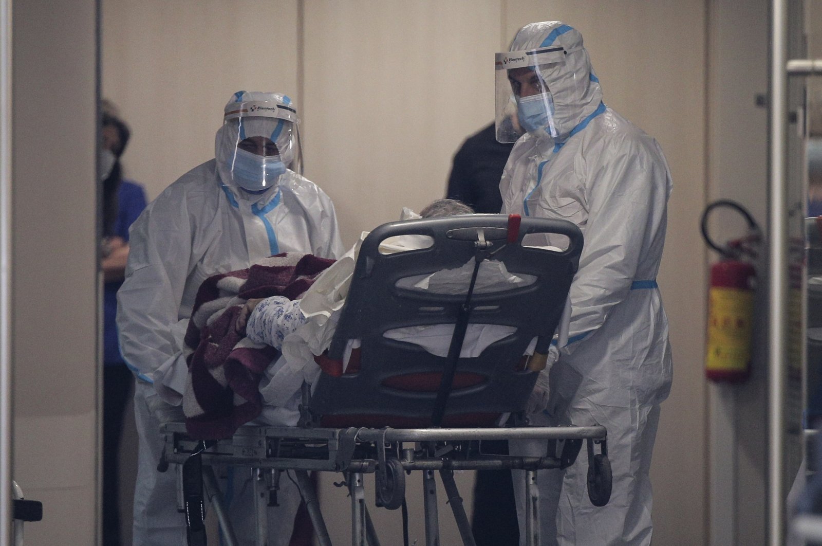 Medical personnel transfer a COVID-19 patient from a state to a private clinic which has been appropriated, in the northern city of Thessaloniki, Greece, Sunday, Nov. 29, 2020. (AP Photo)
