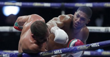 Anthony Joshua lands a blow on Kubrat Pulev during their title fight at Wembley Arena in London, Britain, Dec. 12, 2020. (AP Photo)