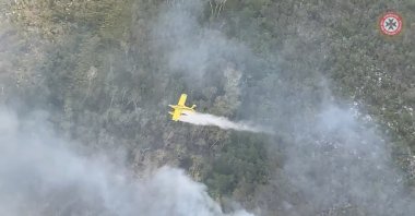 A plane drops water over bushfires on Fraser Island, Queensland, Australia, Nov. 27, 2020. (Queensland Fire and Emergency Services/Handout via Reuters)