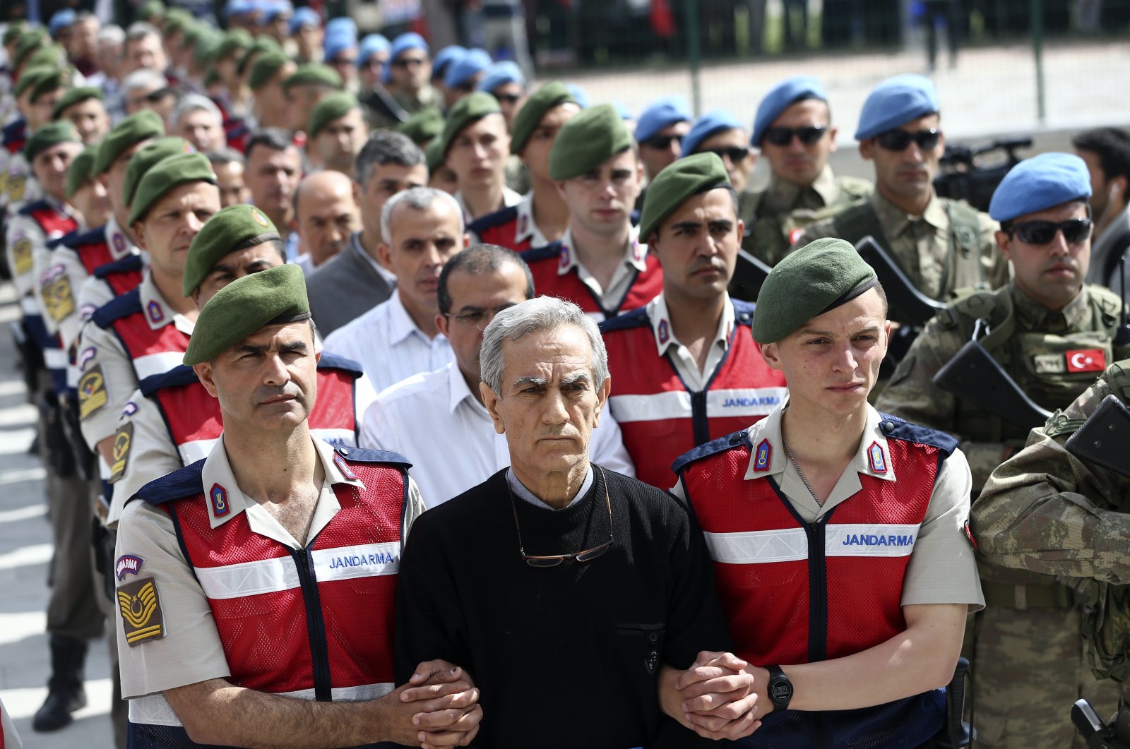 Former four-star Gen. Akın Öztürk, the highest-ranking military member involved in FETÖ's 2016 coup attempt, is escorted by soldiers to appear before a court in Ankara, Turkey, May 22, 2017. (AA Photo)