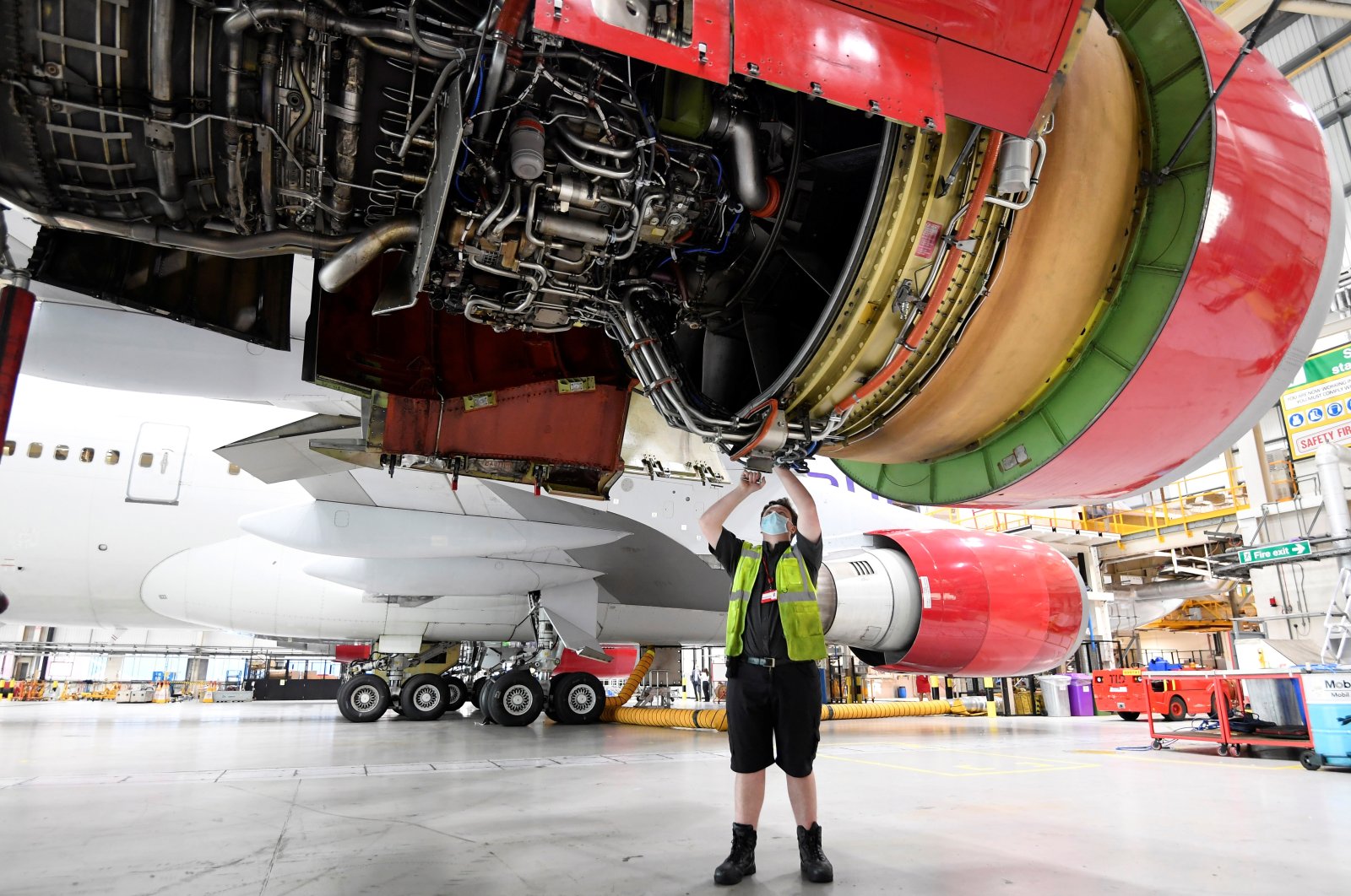 An engineer works on the Boeing 747 jumbo G-VROY, named "Pretty Woman," being retired from passenger service by Virgin Atlantic Airways, before its redeployment as freight and military carrier, in a maintenance hangar at Heathrow Airport, London, Britain, Dec. 11, 2020. (Reuters Photo)