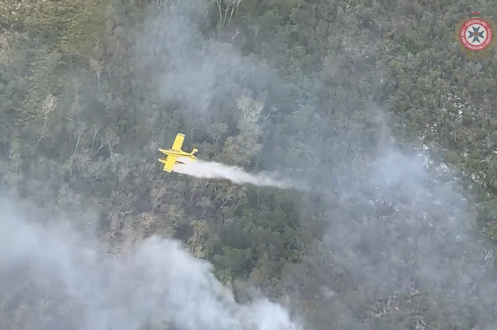 A plane drops water over bushfires on Fraser Island, Queensland, Australia, Nov. 27, 2020. (Queensland Fire and Emergency Services/Handout via Reuters)