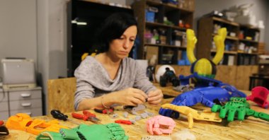 Zeynep Karagöz pieces together robotic hands she printed, in Istanbul, Turkey, Dec. 14, 2020. (AA PHOTO) 
