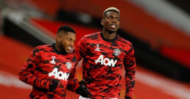 Manchester United's Fred (L) and Paul Pogba warm up ahead of a Premier League match against Manchester City at the Old Trafford stadium in Manchester, England, Dec. 12, 2020. (AFP Photo)