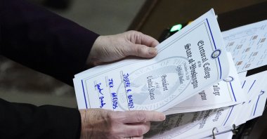 Secretary of State Kim Wyman holds a ballot marked for President-elect Joe Biden that was cast by Jack Arends, a member of Washington's Electoral College, at the state Capitol in Olympia, Wash., Monday, Dec. 14, 2020. (AP Photo)
