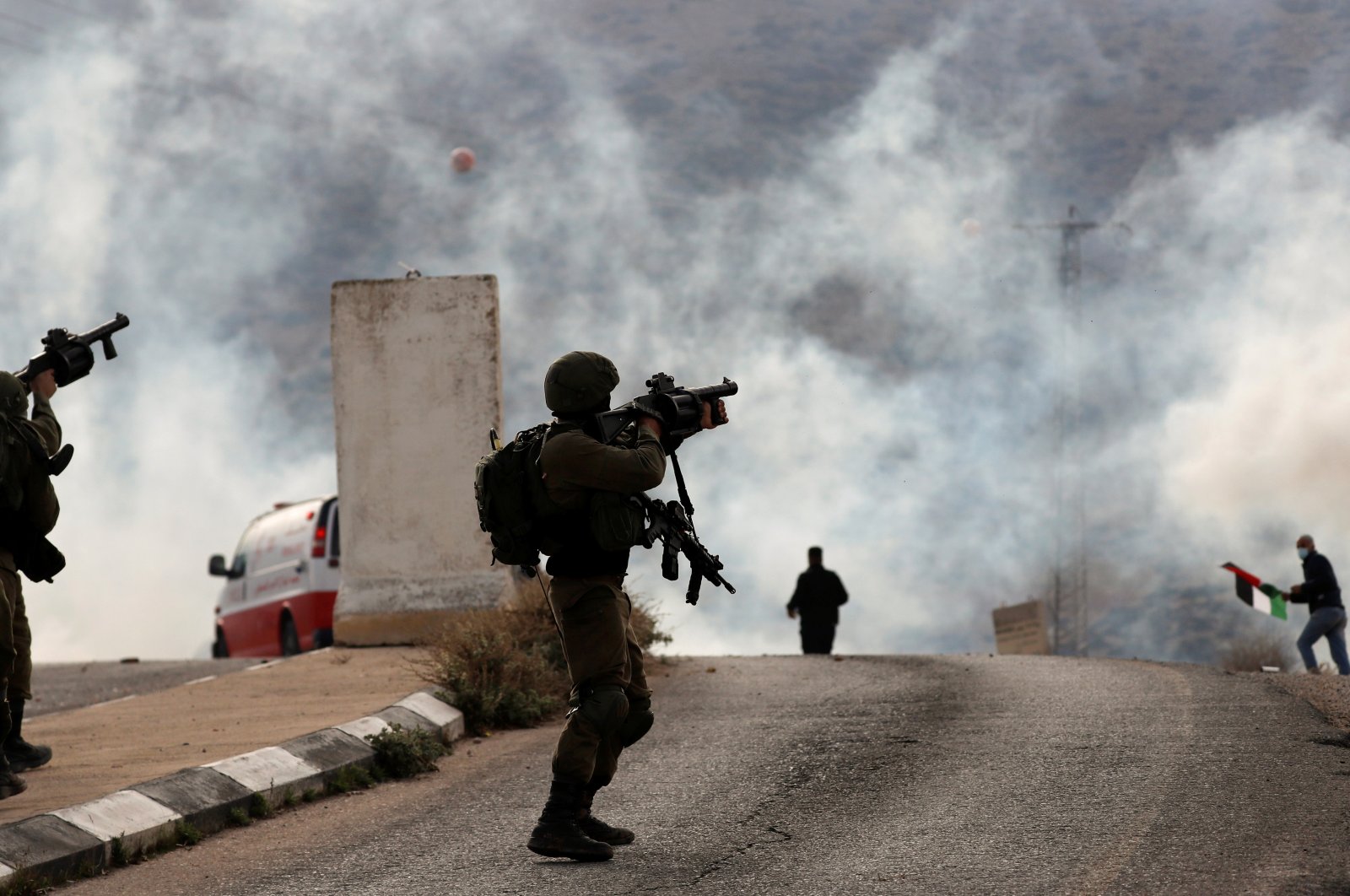 An Israeli soldier fires a tear gas canister toward Palestinian demonstrators during a protest against Jewish settlements in Jordan Valley in the Israeli-occupied West Bank, Palestine, Nov. 24, 2020. (Reuters Photo)