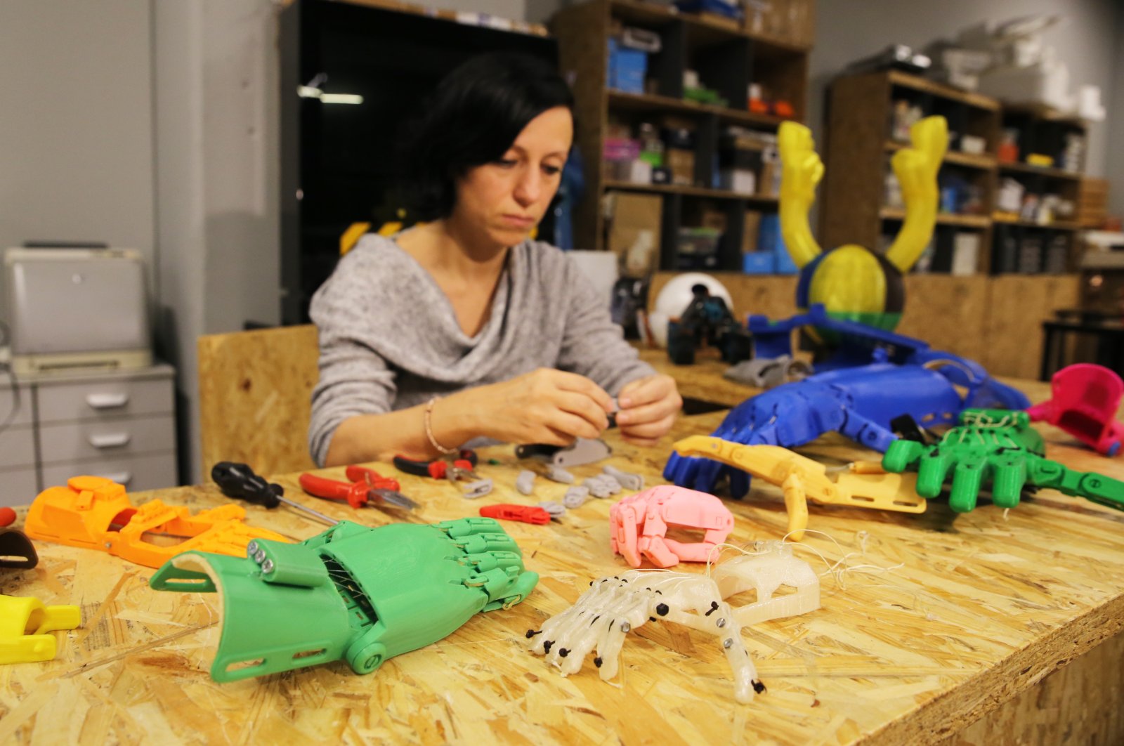 Zeynep Karagöz pieces together robotic hands she printed, in Istanbul, Turkey, Dec. 14, 2020. (AA PHOTO) 