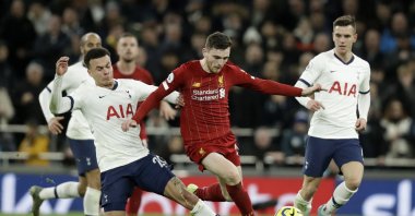 Tottenham's Dele Alli (L) fights for the ball with Liverpool's Andrew Robertson (C) during a Premier League match at the Tottenham Hotspur Stadium in London, England, Jan. 11, 2020. (AP Photo)