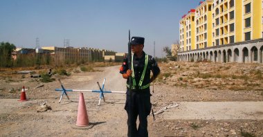 A Chinese police officer takes his position by the road near what is officially called a vocational education center in Yining in the Xinjiang Uighur Autonomous Region, China, Sept. 4, 2018. (Reuters Photo)