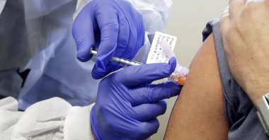 A volunteer receives a shot in the first-stage safety study of Moderna's potential vaccine for COVID-19 at the Kaiser Permanente Washington Health Research Institute in Seattle, Washington, March 16, 2020. (AP Photo)