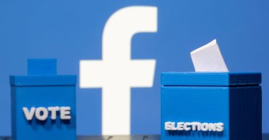 3D printed ballot boxes are seen in front of a displayed Facebook logo in this illustration taken Nov. 4, 2020. (Reuters Photo)