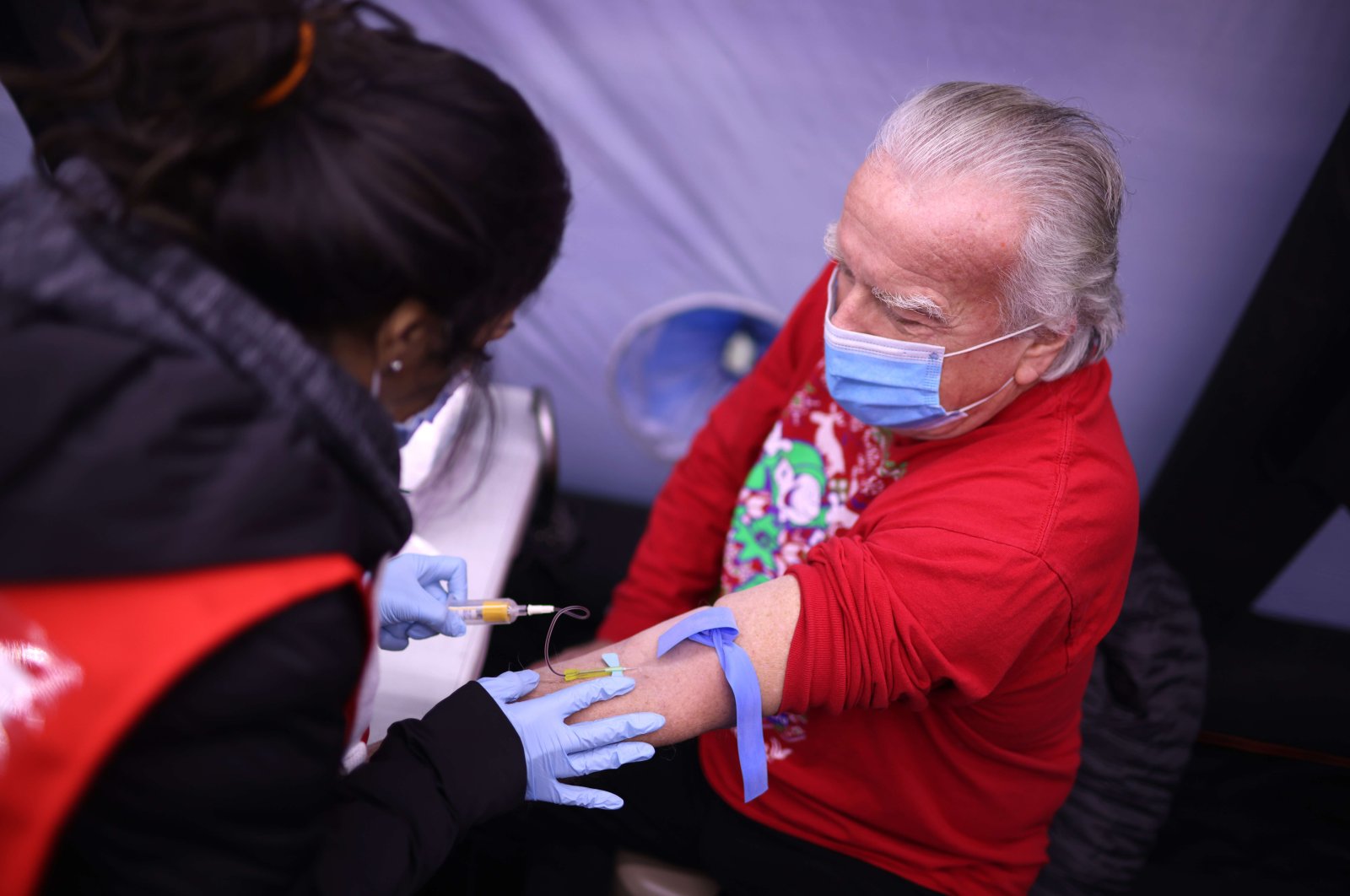 Bill Matusiha gets blood drawn by phlebotomist Randa Ali for a Covid-19 antibody test at a mobile test site being run by Roseland Community Hospital on December 12, 2020 in Chicago, Illinois. (Getty Images/AFP Photo)
