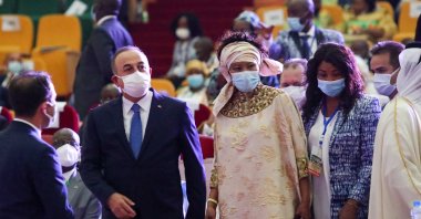 Foreign Minister Mevlüt Çavuşoğlu (L) represented Turkey at the oath-taking ceremony of Guinea's President Alpha Conde held in the capital Conakry, Guinea, Dec. 16, 2020. (AA Photo)