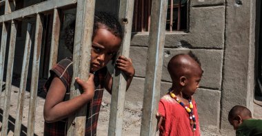 Children play in front of a store damaged by bullets in the village of Bisober, in Ethiopia's Tigray region on Dec. 9, 2020. (AFP Photo)