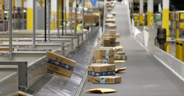 Amazon packages move along a conveyor at an Amazon warehouse facility in Goodyear, Arizona on Dec. 17, 2019. (AP Photo)