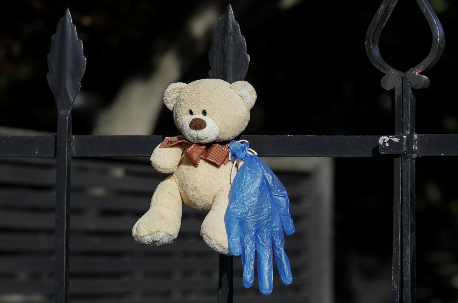A teddy bear hangs on a fence outside a house in Christchurch, New Zealand, on Tuesday, March 31, 2020. (AP Photo)