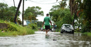 Residents wade through flooded streets in Suva, Fiji, Dec. 16, 2020, ahead of Cyclone Yasa. (AFP Photo)