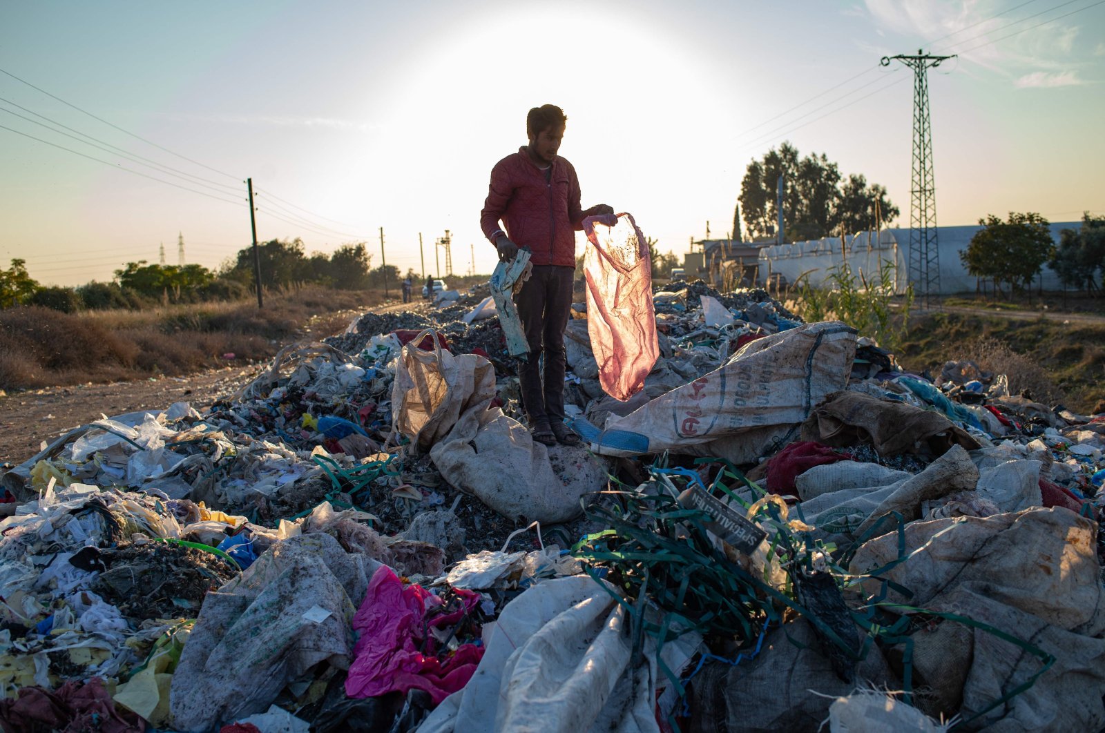 A man collects items from an illegal dump in Adana, southern Turkey, on November 29, 2020. (AFP Photo)