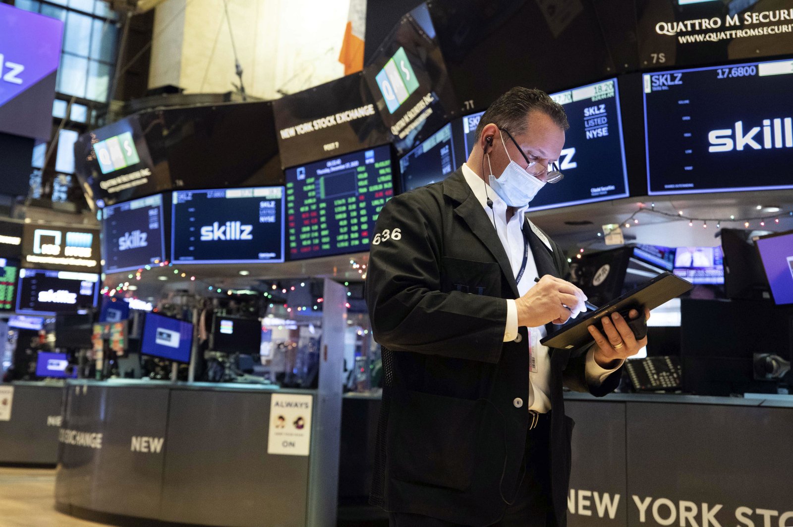 In this photo provided by the New York Stock Exchange, trader Edward Curran works on the floor, Thursday, Dec. 17, 2020. (Colin Ziemer/New York Stock Exchange via AP)