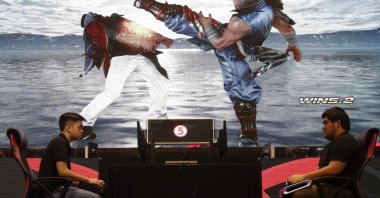 Two players battle in the video game Tekken 7 to qualify for the Philippine esports team, in Manila, Philippines, Aug. 29, 2019. (AP Photo)