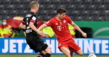 Bayern Munich's Robert Lewandowski (R) in action with Bayer Leverkusen's Sven Bender during a German Cup match at the Olympiastadion stadium in Berlin, Germany, July 4, 2020. (AP Photo)