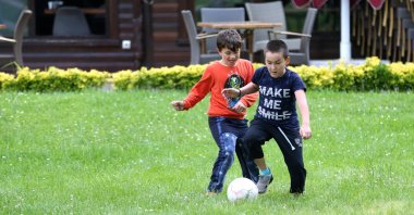 Two boys play football in a yard in Sakarya, northwestern Turkey, June 3, 2020. (AA Photo)