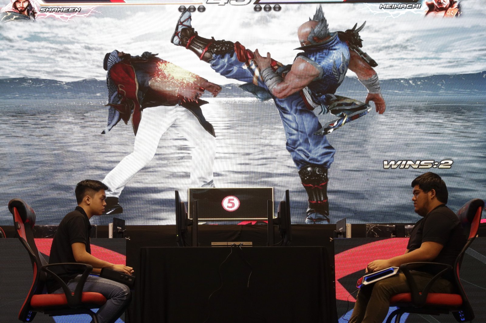 Two players battle in the video game Tekken 7 to qualify for the Philippine esports team, in Manila, Philippines, Aug. 29, 2019. (AP Photo)