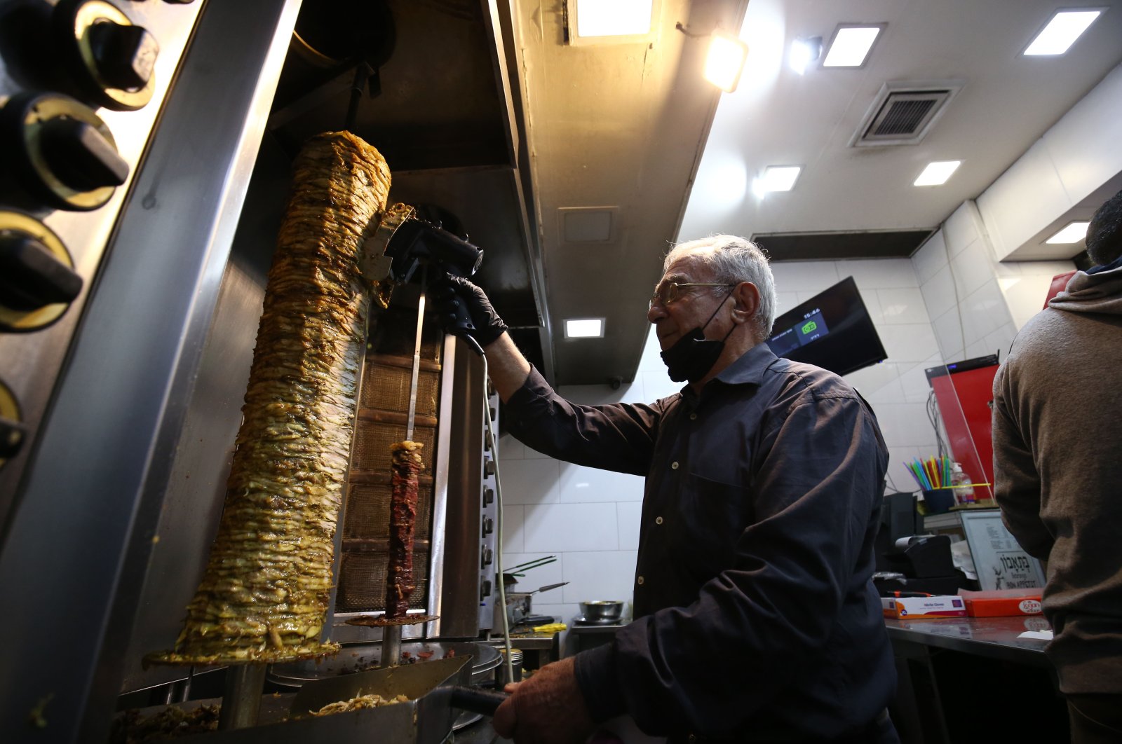 Eli Gezici works in his kebab shop in West Jerusalem, Israel, Dec. 17, 2020. (AA Photo)