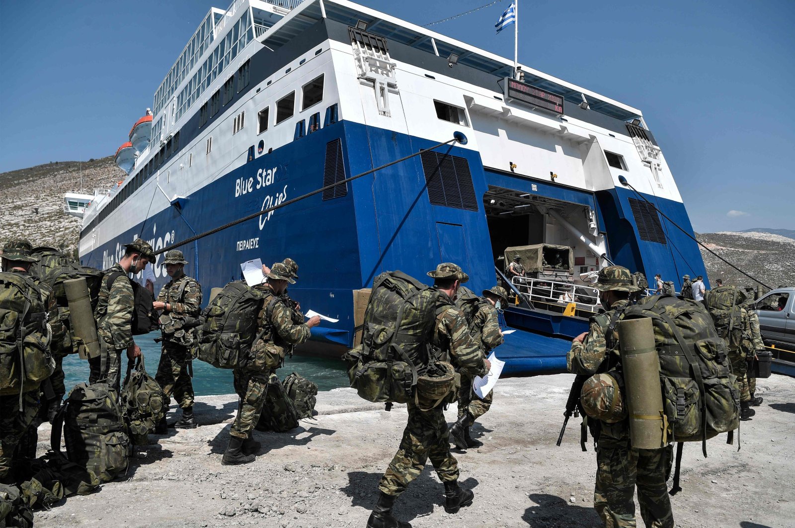 Greek soldiers prepare to board a ferry at the port of the tiny Greek island of Kastellorizo (Megisti-Meis), the most southeastern inhabited Greek island in the Dodecanese, situated two kilometers off the south coast of Turkey, Aug. 31, 2020. (AFP Photo)