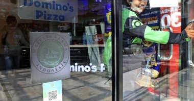 The Indonesian Ulema Council's "halal" logo on the facade of a restaurant in Jakarta, Indonesia, Wednesday, Nov. 11, 2020. (AP Photo)