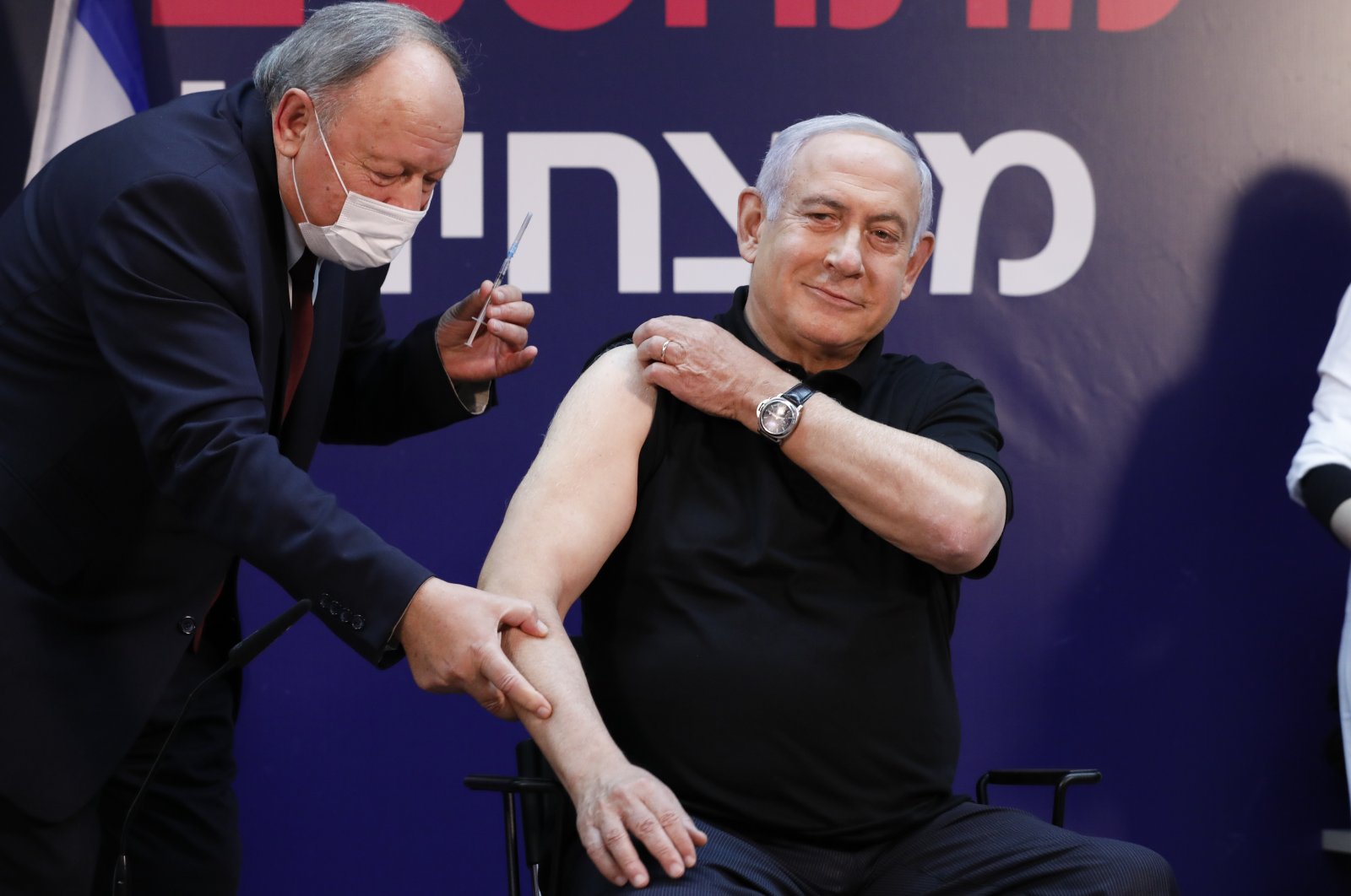 Israeli Prime Minister Minister Benjamin Netanyahu receives a coronavirus vaccine at Sheba Medical Center in Ramat Gan, Israel on Saturday, Dec. 19, 2020. (Amir Cohen/Pool via AP)