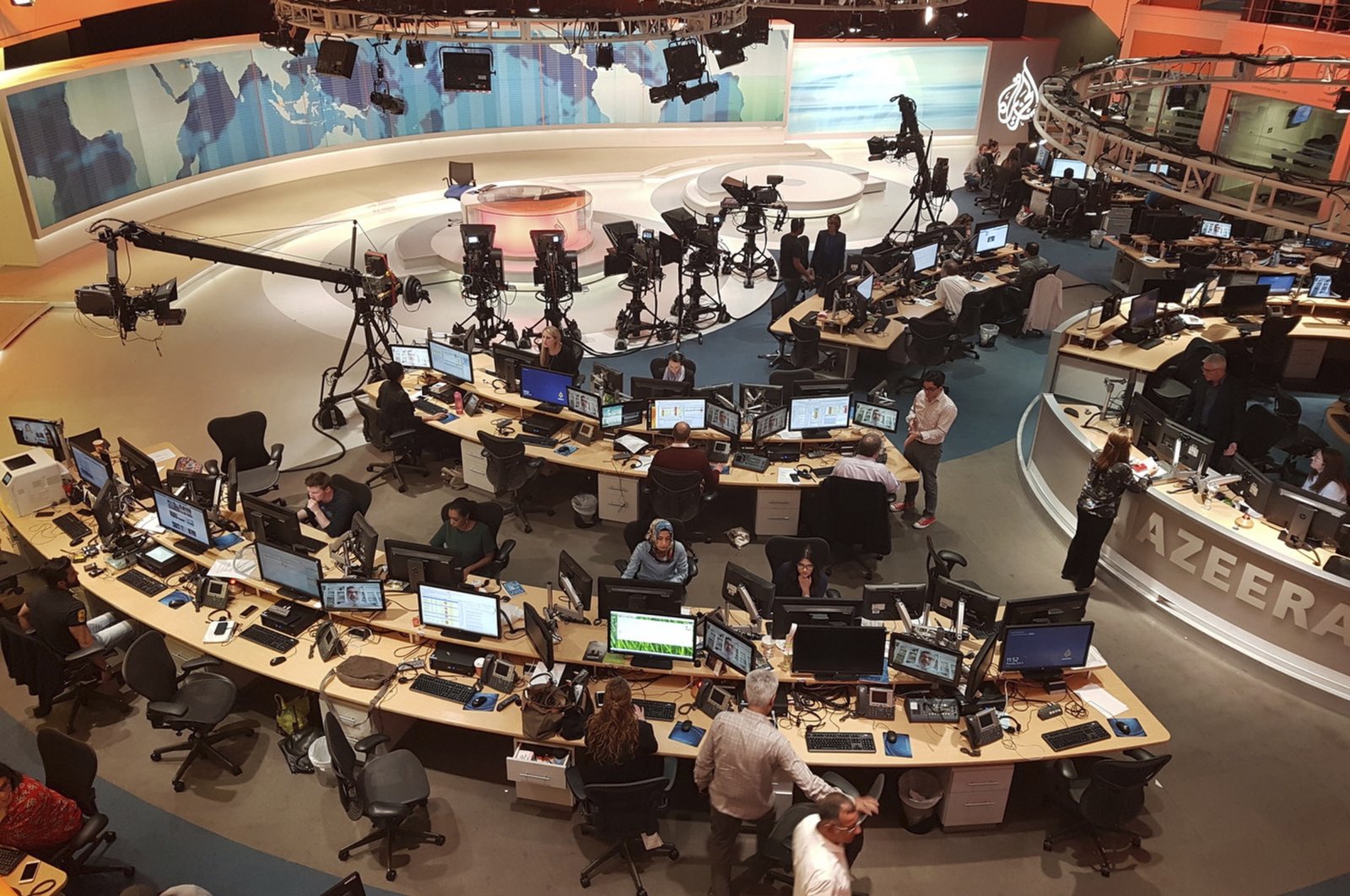 Al Jazeera staff work at their TV station in Doha, Qatar, June 8, 2017. (AP Photo)