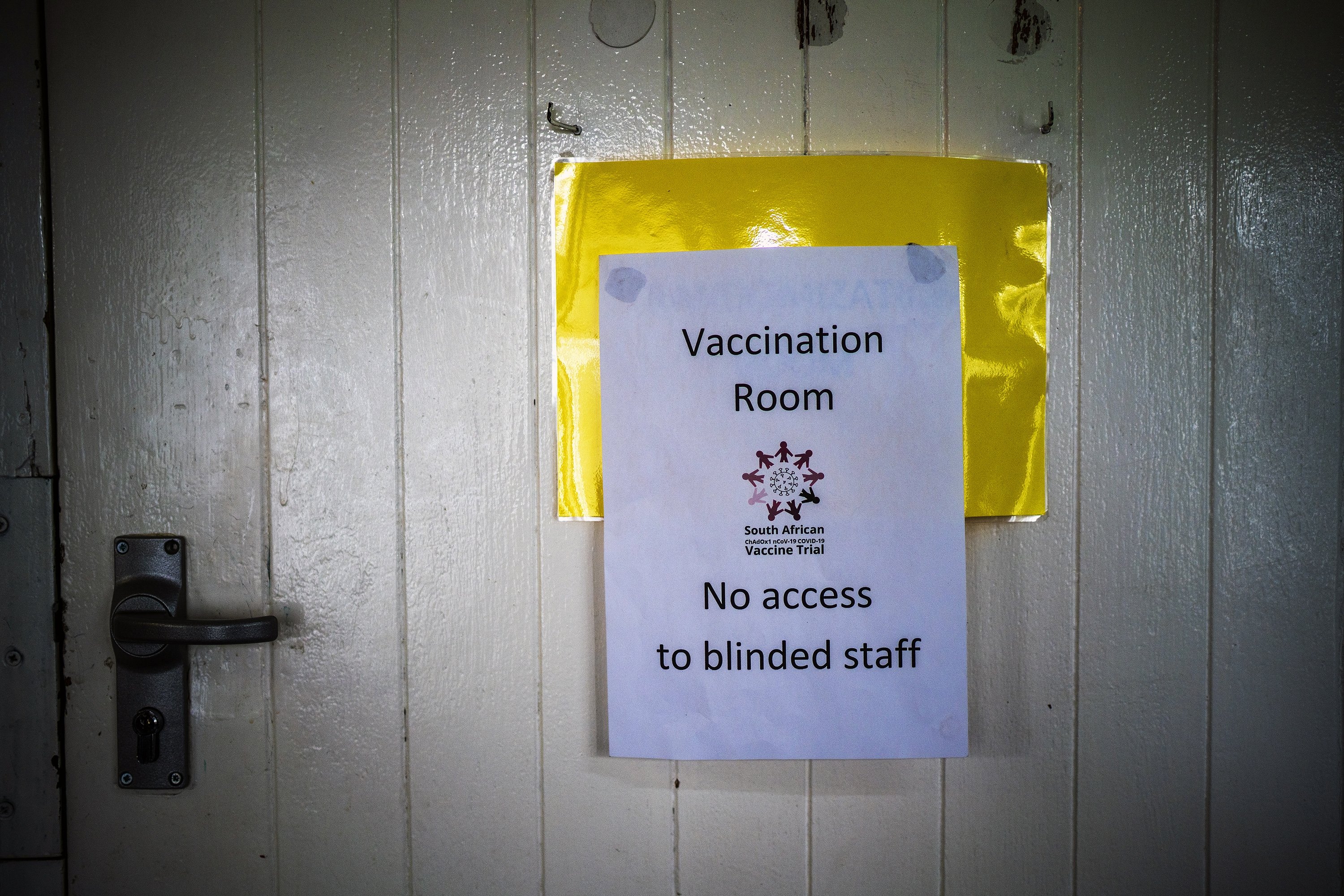 A sign restricting access is posted on a door at a vaccine trial facility set at Soweto's Chris Sani Baragwanath Hospital outside Johannesburg, South Africa, Monday Nov. 30, 2020. Over 2000 South African volunteers are on AstraZeneca's experimental coronavirus vaccine trial. (AP Photo/Jerome Delay)