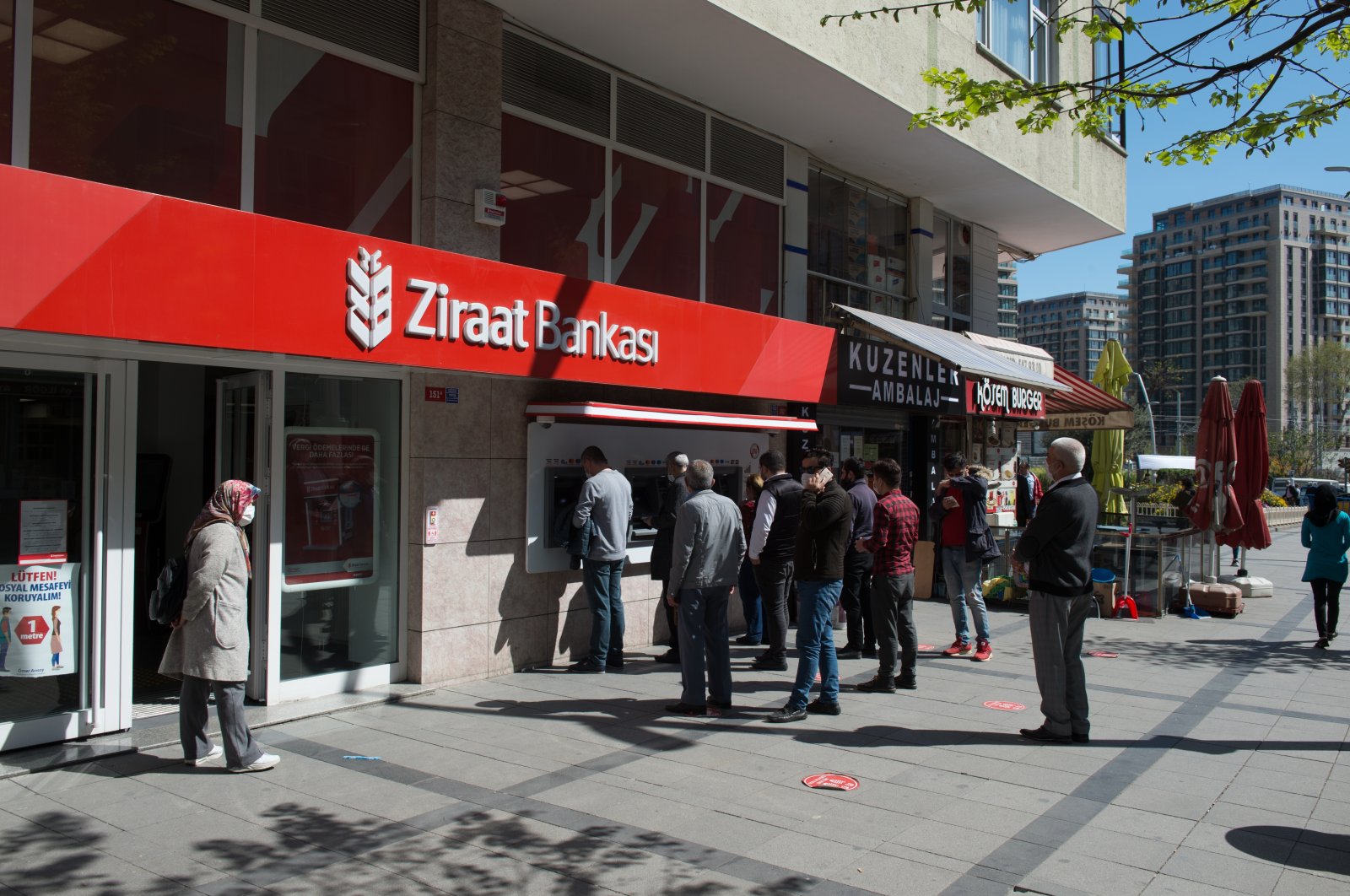 People are seen waiting in front of a Ziraat Bank branch in Zeytinburnu district, Istanbul, Turkey, April 30, 2020. (Shutterstock Photo)
