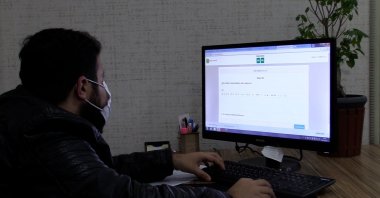 A student takes an online exam on a computer in the Karaköprü Municipality in Şanlıurfa province, southeastern Turkey, Nov. 24, 2020. (IHA Photo)