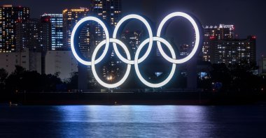 The giant Olympic rings illuminated on display at the waterfront area at Odaiba Marine Park in Tokyo, Japan, Dec. 1, 2020. (AFP Photo)