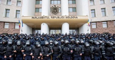 Moldovan law enforcement officers stand guard during a rally of farmers and agrarians, who demand governmental support and financial aid near the parliament building in Chisinau, Moldova, Dec. 16, 2020. (Reuters Photo)