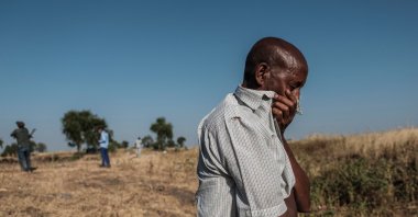 A man reacting as he stands near a ditch in the outskirts of Mai Kadra, Ethiopia, that is filled with more than 20 bodies of victims that were allegedly killed in a massacre, Nov. 21, 2020. (AFP Photo)