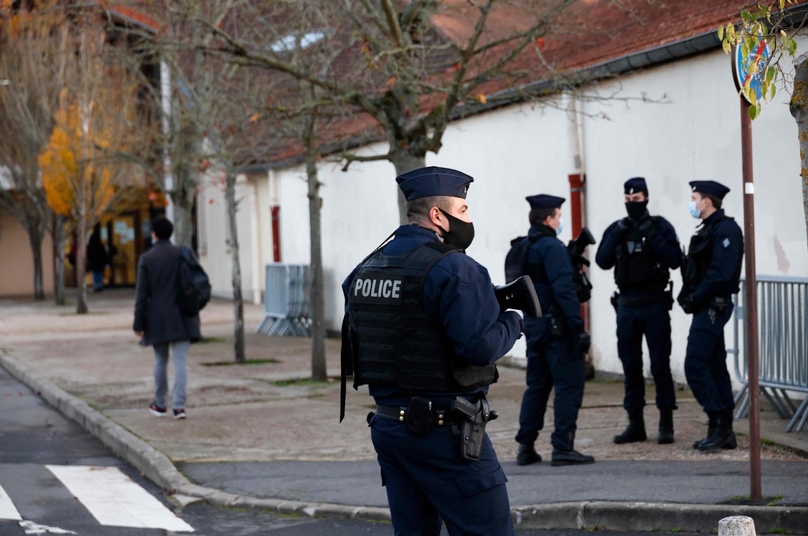 French CRS (Compagnies Republicaines de Securite) police officers stand near the entrance of Le Bois d'Aulne middle school in Conflans-Sainte-Honorine, 30 kilometers northwest of Paris, on Nov. 3, 2020. (AFP)