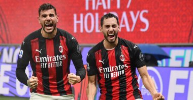 AC Milan's Theo Hernandez (L) and Hakan Çalhanoğlu celebrate a goal during a Serie A match against Lazio at the San Siro Stadium, Milan, Italy, Dec. 23, 2020. (AP Photo)