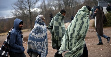 Migrants leave the Lipa center following a fire in Bihac, Bosnia-Herzegovina, Dec. 24, 2020. (Reuters Photo)