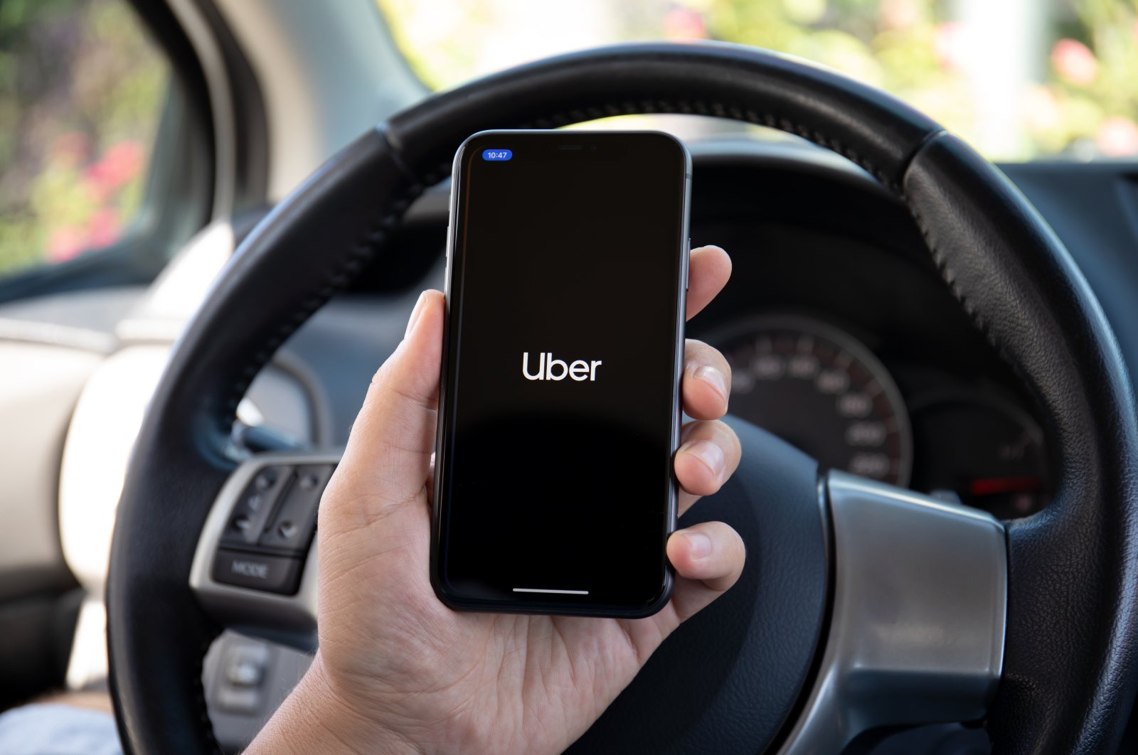 A man holds a mobile phone showing the Uber Taxi application on the screen, Antalya, southern Turkey, Oct. 5, 2020. (Shutterstock Photo)