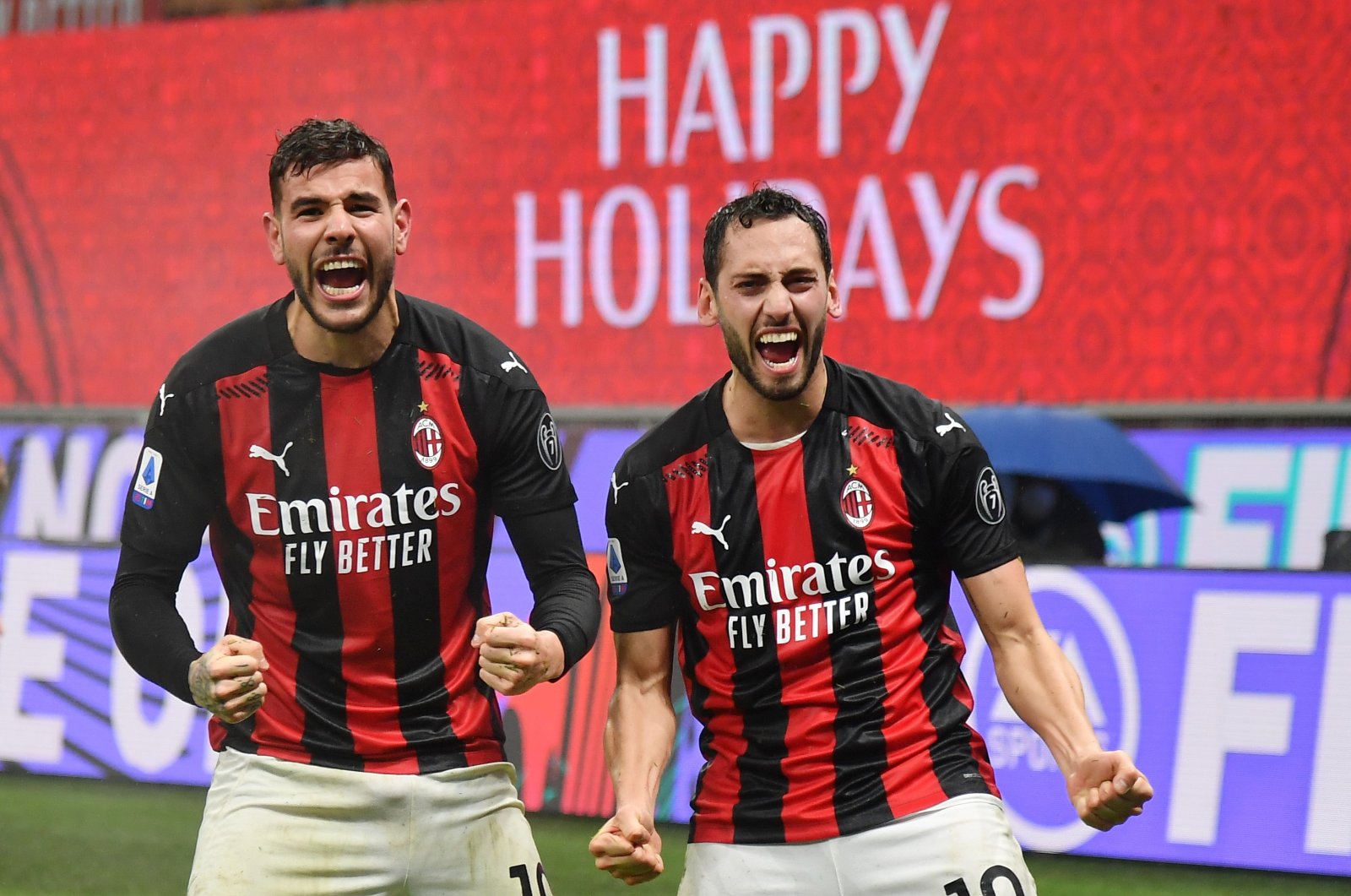 AC Milan's Theo Hernandez (L) and Hakan Çalhanoğlu celebrate a goal during a Serie A match against Lazio at the San Siro Stadium, Milan, Italy, Dec. 23, 2020. (AP Photo)