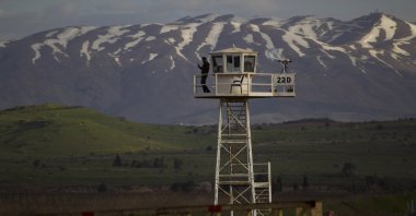 A U.N. peacekeeper stands guard on a watch tower at the Quneitra crossing between Syria and the Israeli-occupied Golan Heights, March 8, 2013. (AP Photo)