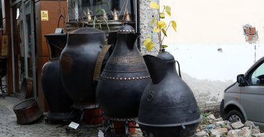 Giant copperware by Ali Çavuş is displayed in front of his workshop in Trabzon, northern Turkey, Dec. 24, 2020. (AA PHOTO)